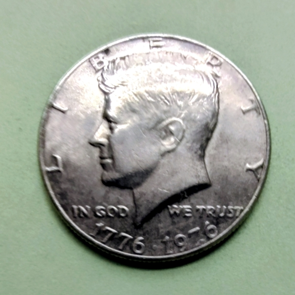 1976-P Bicentennial Kennedy Half Dollar Coin In Good Circulated Condition.